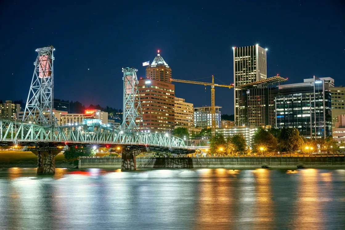 Portland’s Hawthorne Bridge and downtown skyline reflected in the Willamette River at dusk